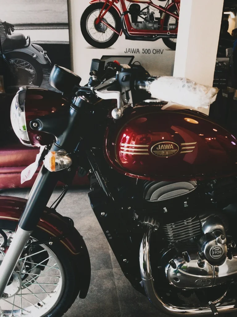Maroon Jawa motorcycle on display in a dealer showroom