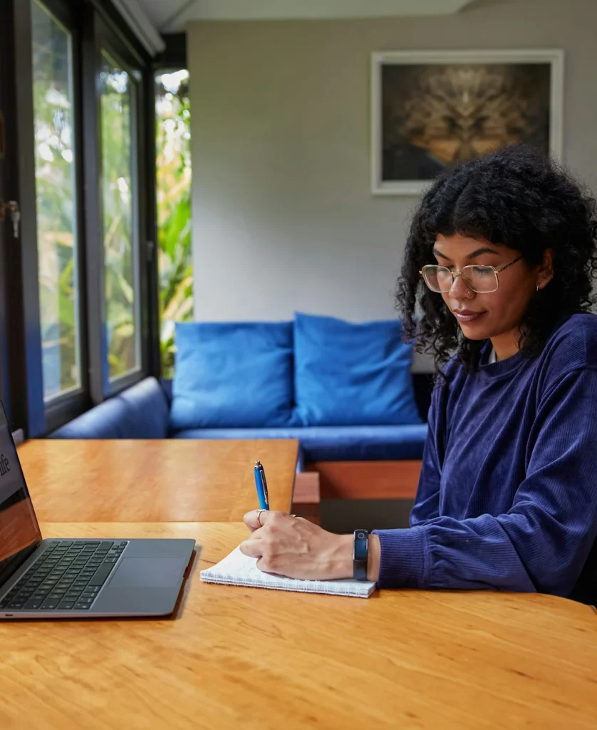 A learner taking notes during a live online class